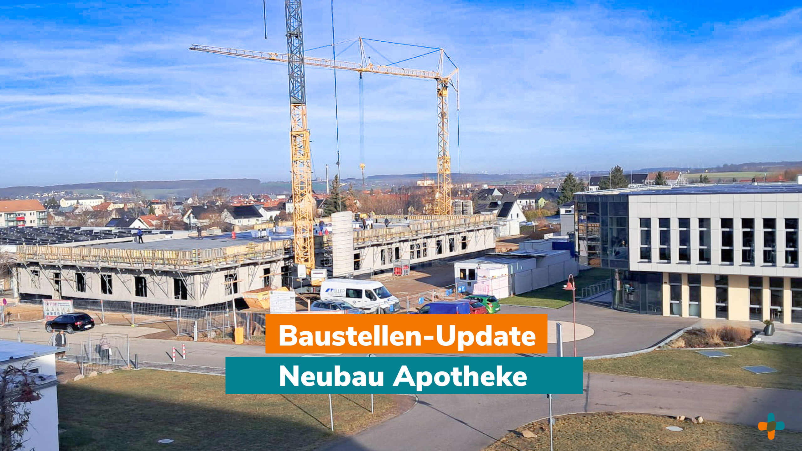 Aktueller Baufortschritt für die Neubau Apotheke. Eine Außenaufnahme der Baustelle mit dem Rohbau des Gebäudes, dominiert von zwei großen Baukranen. Text-Overlay: "Baustellen-Update".